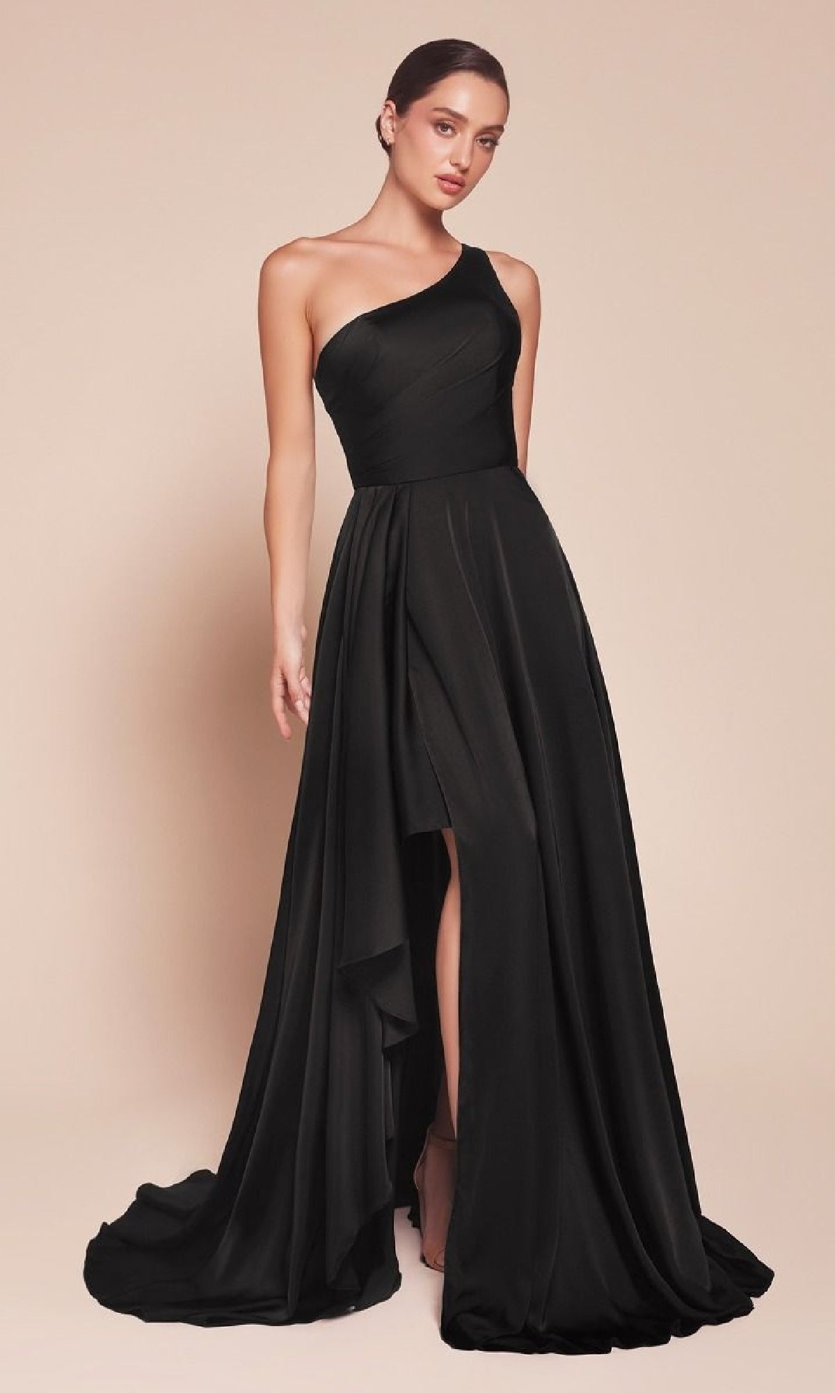 A woman poses against a beige background in the One-Shoulder Long A-Line Prom Dress: Ladivine 7450—a stylish, affordable formal gown featuring a floor-length skirt, front slit, and graceful draping.